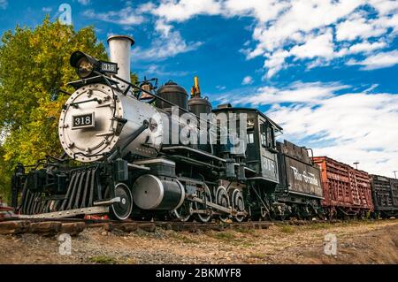 Colorado Railroad Museum displaying the Denver & Rio Grande Western Steam Locomotive No. 318  pulling freight wagons. Denver, Colorado, USA. Stock Photo