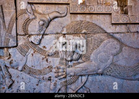Bas-relief of lion devouring bull representing zoroastrian Nowruz, Persepolis, Iran. Stock Photo