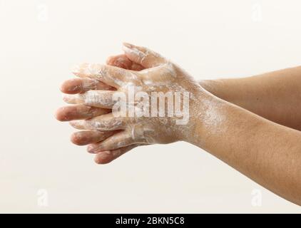 hands with soap foam on white background Stock Photo