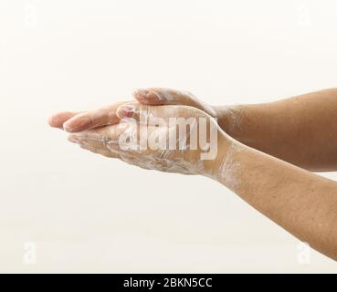 hands with soap foam on white background Stock Photo