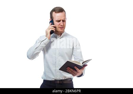 man businessman, teacher, mentor examines entries in your diary and talking on a cell phone. Isolated on white background Stock Photo