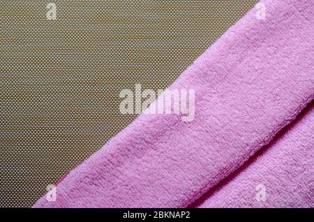 Soft pink towels on a brown background. Colorful bath towels. Health and hygiene care. View from above. Place for text. Stock Photo