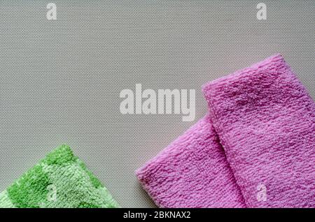 Soft multi-colored towels on a white textured background. Colorful bath towels. Health and hygiene care. View from above. Place for text. Stock Photo