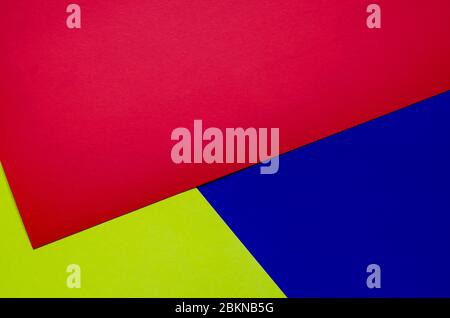 Multicolored paper background. Paper sheets of rainbow colors close-up. Geometric multitask background. Place for text. View from above. Stock Photo