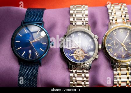 Three luxury sport Matteo Ferari male watches on bronze background . Stock Photo