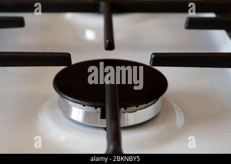 gas ring on the stove with cast iron grate . Stock Photo