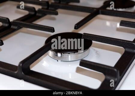 gas ring on the stove with cast iron grate . Stock Photo