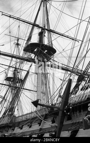 H.M.S. Victory, Nelson's flagship at the Battle of Trafalgar in No. 2 Dry Dock, Portsmouth Naval Base, Hampshire, England: close-up of the fighting tops, showing masts and rigging before the removal of the topmasts for restoration in 2011.  Black and white film photograph Stock Photo