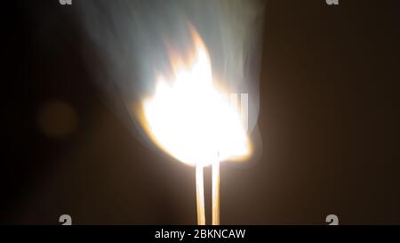 Couple of matches burning together with heat flame isolated on a black background Stock Photo