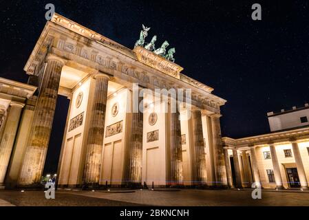 Low angle view of the Brandenburg Gate in Berlin at night with stars in sky. Germany Stock Photo