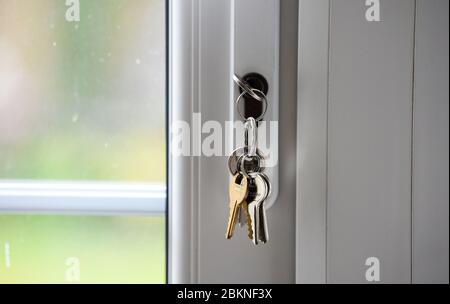 Batch of household door keys hanging in lock