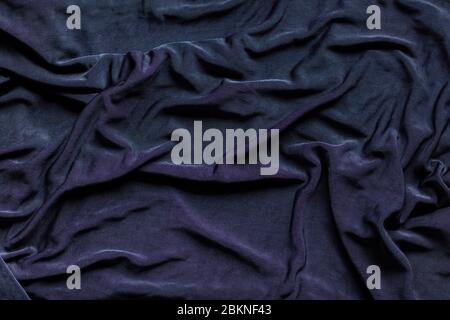 Wrinkly and elegant royal blue colored luxury cloth texture, can be used as an abstract background. Polyester fabric, textile flat lay Stock Photo