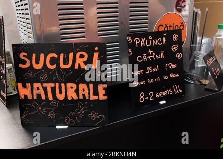 Closeup of natural juice machine, romanian stall in shop store counter in summer Stock Photo