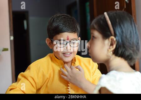 candid shot of cute young brother and sister on the occasion of raksha bandhan festival Stock Photo