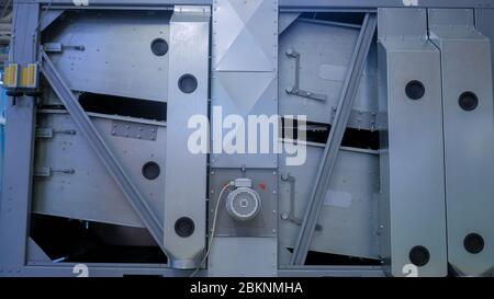 Food production, agriculture industry and automated technology equipment concept. Stationary sieve feed mixer agricultural machine during work at Stock Photo