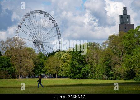 05 May 2020, Saxony-Anhalt, Magdeburg: A Ferris wheel stands in the Rotehorn Park next to the Albin Müller Tower. Currently, the operators are working out a concept to comply with the distance rules. The Ferris wheel was erected in the past weeks and is operated by the Boos brothers from Magdeburg. Actually the ride should have been operated at other fairs at the moment. But they had been cancelled due to the spread of the corona virus. Now the Ferris wheel is in the state capital and is supposed to start operation in the coming weeks without the fair. Photo: Klaus-Dietmar Gabbert/dpa-Zentralb Stock Photo