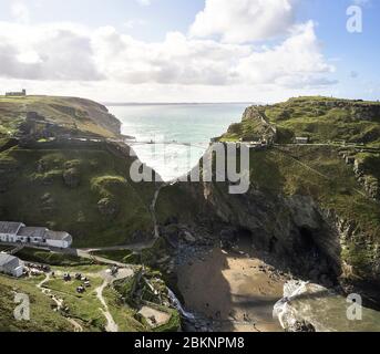 Distant view from elevated position with visitors walking on bridge. Tintagel Bridge, Tintagel, United Kingdom. Architect: William Matthews Associates Stock Photo