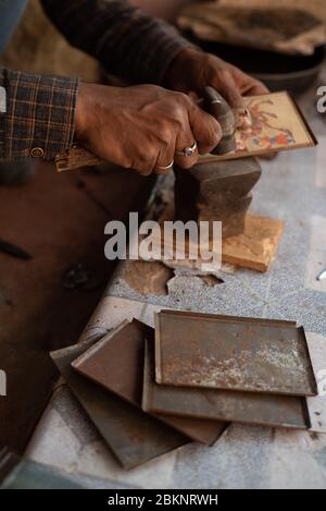 Close-up of man framing miniature paintings.  Bundi, Rajasthan, India Stock Photo