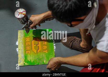 Quezon City, Philippines. 5th May, 2020. A worker paints social distancing markers inside a train at the Light Rail Transit Line-2 (LRT-2) depot in Quezon City, the Philippines, on May 5, 2020. Credit: Rouelle Umali/Xinhua/Alamy Live News Stock Photo