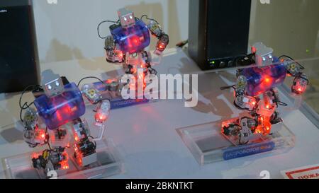 MOSCOW, RUSSIA - July 30, 2018: Robostation - future exhibition. Humanoid robots with colourful illumination dancing at technology exhibition. Future Stock Photo