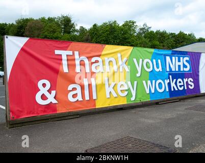 Large colourful rainbow banner, in gratitude to all NHS medical staff and keyworkers who are working during the UK Coronavirus pandemic crisis. Stock Photo