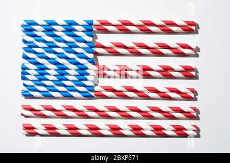 Coloured straws in red and white and blue and white laid out to look like the American flag. Stock Photo