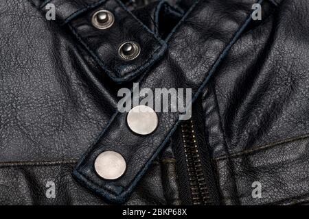 close up of a black leather vintage motorcycle jacket, zipper and press studs. Stock Photo