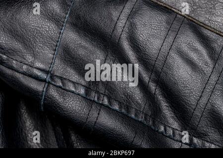 close up detail of a black leather vintage motorcycle jacket Stock Photo