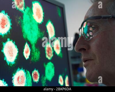 Scientist viewing a image of virus using a electron microscope in the laboratory. Stock Photo
