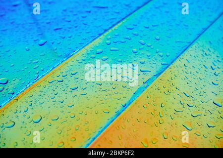 Chameleon holographic colour car after the rain. Side mirror with water  drops closeup. Car wrapping. Rainy day Stock Photo - Alamy