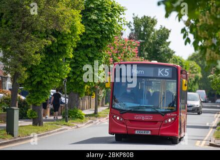 Merton, London, UK. 5 May 2020. Coronavirus lockdown day 43. Sunshine after a hazy start in London with local people maintaining social distancing while taking exercise. Driver of an almost empty London bus wears a protective mask. Credit: Malcolm Park/Alamy Live News. Stock Photo