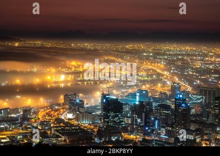 View of Cape Town fog coming in over city harbour at night South Africa Stock Photo