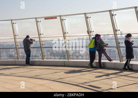 Beijing / China - February 20, 2016: People enjoying in the areal view of Beijing from the Olympic Park Observation Tower Stock Photo