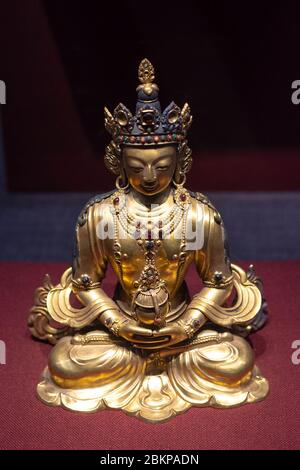 Beijing / China - February 20, 2016: Golden statue of a seated crosslegged Buddha exhibited in National Museum of China in Beijing Stock Photo