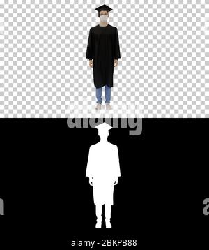 Young man with graduation gown in medical mask, Alpha Channel Stock Photo