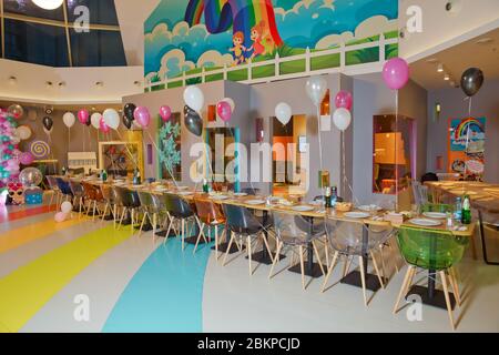 First birthday party of a baby concept made of white , black and pink colors balloons . Luxury decorated table for birthday in a restaurant Stock Photo