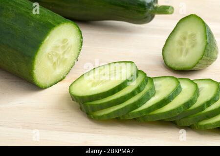 Fresh green cut cucumber and slices with juicy seeds Stock Photo