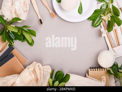 Eco craft paper tableware. A box of paper for food, packaging, Toothbrush, plate, forks, knives, eco bag with fruits on a gray background. world is free of plastic. Recycling concept eco-friendly .  Stock Photo