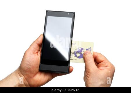 Male hands holding wireless pos terminal and banking card Stock Photo