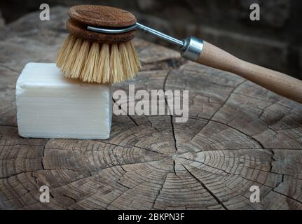 wooden  scubbing or dish brush and soap on wood table. concept zero  waste.; Stock Photo