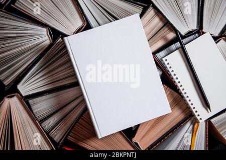 Mockup layout and a black pencil lie on multicolored open books Stock Photo