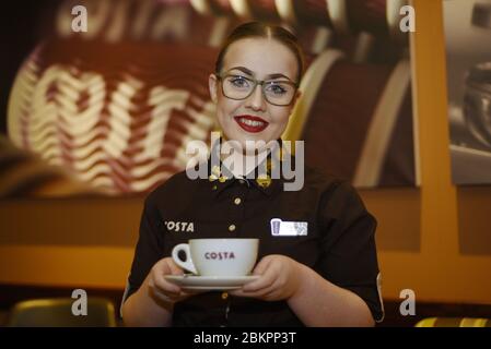 Costa coffee shop worker in store - a barista making coffee Stock Photo