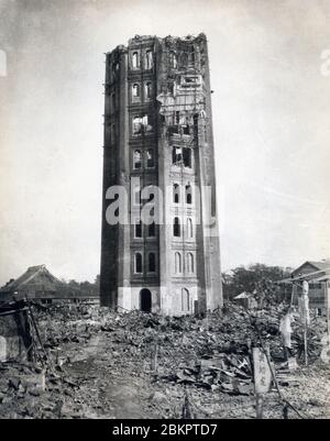 [ 1920s Japan - Great Kanto Earthquake ] —   The ruins of Ryounkaku (凌雲閣) at Asakusa Park in Tokyo after the Great Kanto Earthquake (Kanto Daishinsai) of September 1, 1923 (Taisho 12).  Japan’s very first skyscraper, and better known as Asakusa Junikai (浅草十二階, Asakusa Twelve Stories), the tower was Tokyo’s most famous symbol.  Designed by Scottish engineer W. K. Burton, the tower was completed in 1890 (Meiji 23). It housed Japan’s first electric elevator.  20th century vintage gelatin silver print. Stock Photo