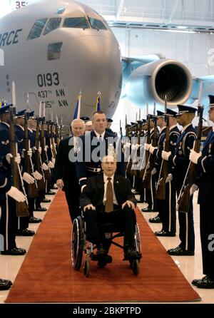 In this photo released by the United States Air Force, US Senator Strom Thurmond (Republican of South Carolina), seated in wheel chair, is helped through a US Air Force Honor Guard Cordon to cut a cake commemorating his 100th birthday during a ceremony at Andrews Air Force Base, Maryland, December 12, 2002. During the ceremony the 100th C-17 Globemaster III to roll off the assembly line was christened 'The Spirit of Strom Thurmond.' Thurmond, an Army combat veteran of World War II, has been a US Senator for 48 years and is a member of the US Senate Armed Services and Veterans' Affairs commit Stock Photo