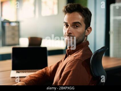 Businessman working late at a desk in an office Stock Photo