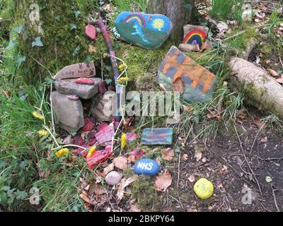 Painted stones with messages of gratitude for NHS at secret 'fairy garden' by river in Sheffield, UK, which has sprung up during Coronavirus Lockdown