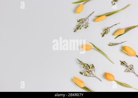 Pattern made of yellow flowers on a blue pastel background. Floral concept with place for text. Stock Photo