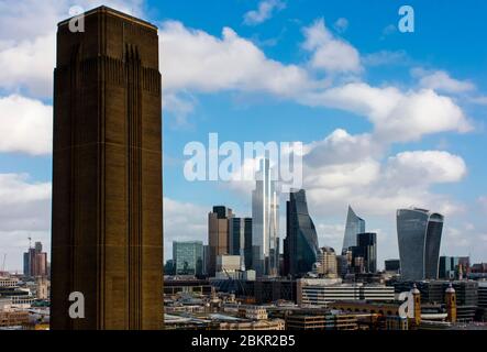 View of the City of London financial district skyline with the chimney block of the Tate Modern Art Gallery in the foreground. Stock Photo