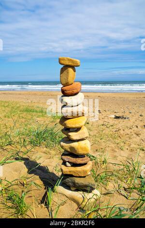 A pile of carefully balanced stones on a North Yorkshire beach Stock Photo