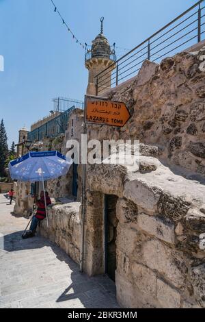 Palestine, Bethany, Occupied West Bank, The entrance to Lazarus' Tomb in Bethany in the Occupied West Bank. Behind is the minaret of the al-Uzair Mosque. Stock Photo